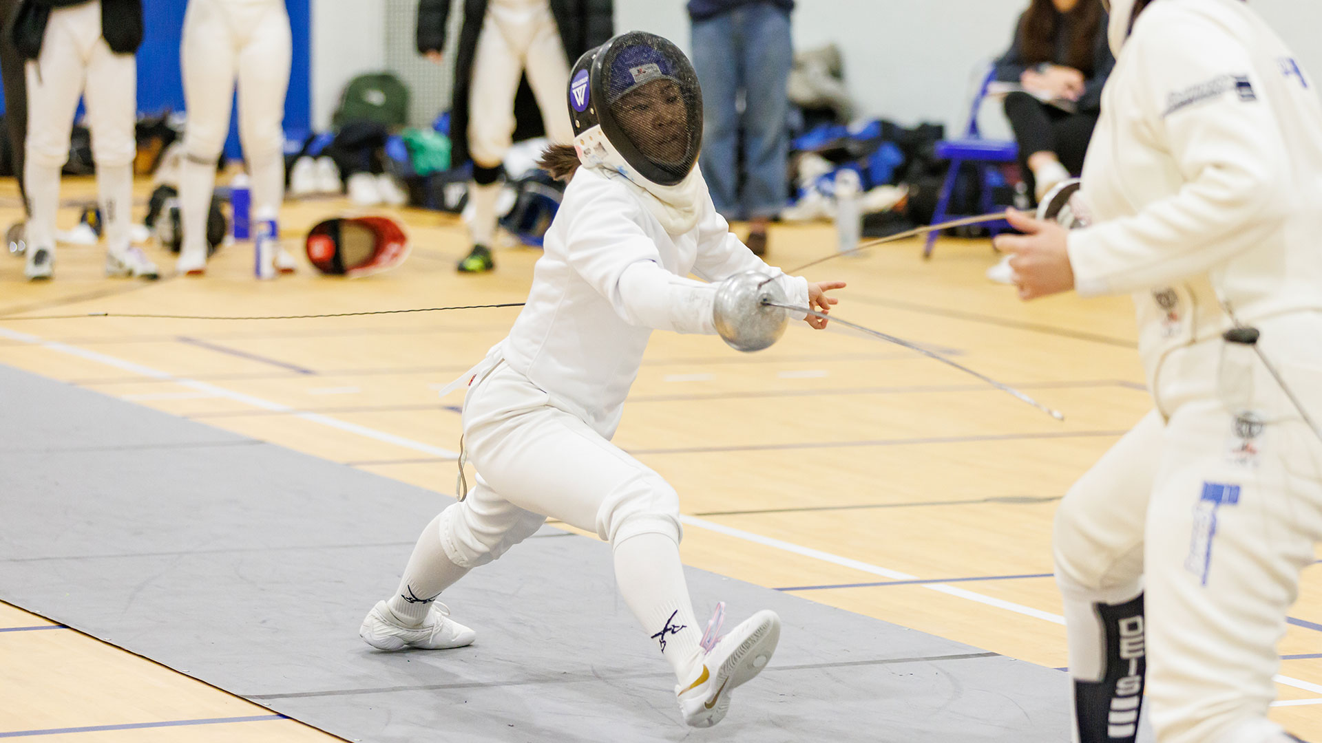 Sharon Huang '26 and Wellesley College fencing open the season at the Shark Tank Challenge on October 22 (Frank Poulin)